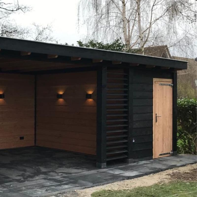 Vrijstaande veranda met houten wand en inbouwverlichting op een bestrate ondergrond
